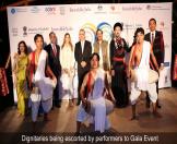 Dignitaries being escorted by performers to Gala Event 